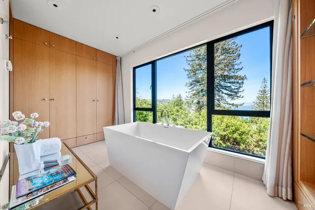 a view of a patio with couches table and chairs with potted plants