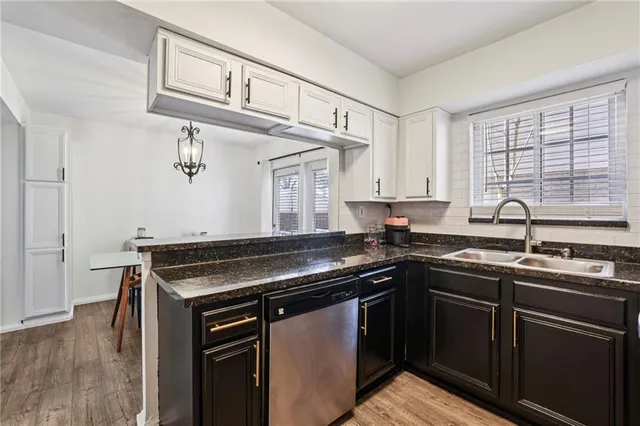 a kitchen with stainless steel appliances granite countertop a sink stove and cabinets