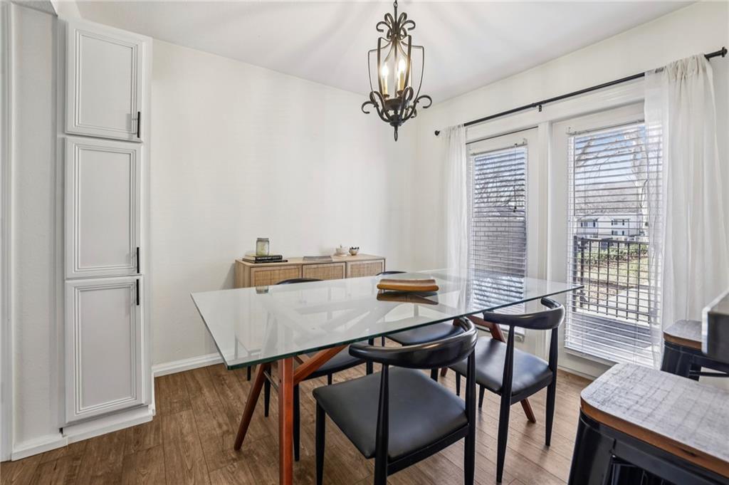 6940 Roswell Road, Unit A21 Atlanta, GA 30328 - Photo 13 of 25 a view of a dining room with furniture window and wooden floor