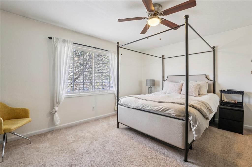 6940 Roswell Road, Unit A21 Atlanta, GA 30328 - Photo 14 of 25 a bedroom with a bed and a window