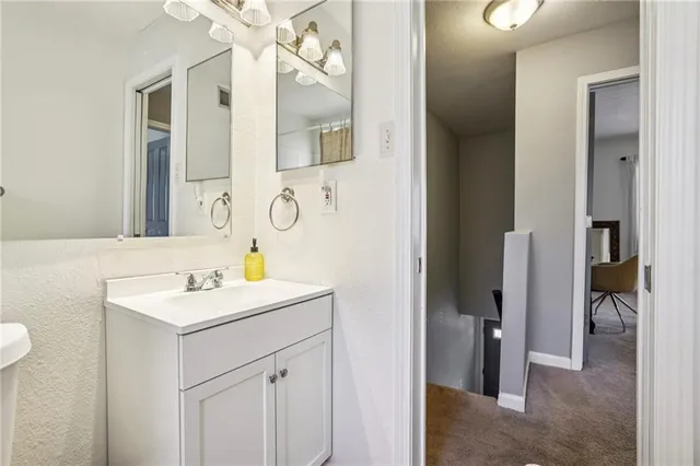 a bathroom with a sink vanity and a mirror