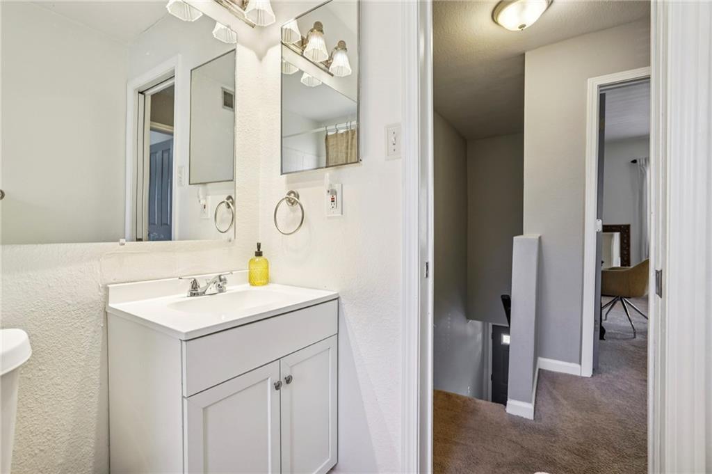 6940 Roswell Road, Unit A21 Atlanta, GA 30328 - Photo 18 of 25 a bathroom with a sink vanity and a mirror