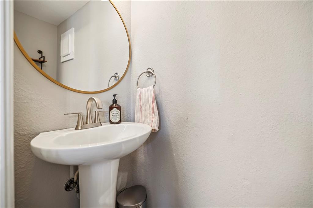 6940 Roswell Road, Unit A21 Atlanta, GA 30328 - Photo 20 of 25 a bathroom with a sink a mirror and a shower