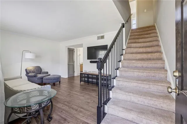 a living room with furniture and a dining table