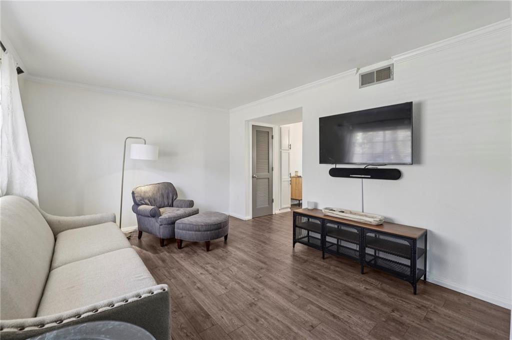 6940 Roswell Road, Unit A21 Atlanta, GA 30328 - Photo 4 of 25 a living room with furniture and a flat screen tv