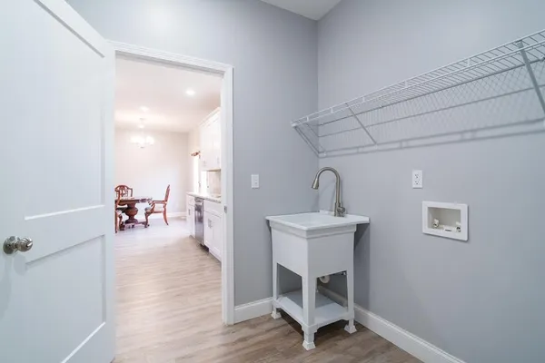 a bathroom with granite countertop white cabinets and a sink