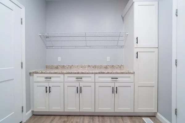 a view of an empty room with furniture and a ceiling fan