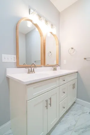 a kitchen with granite countertop white cabinets and a window