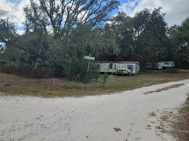 a view of a yard with a car park side of road