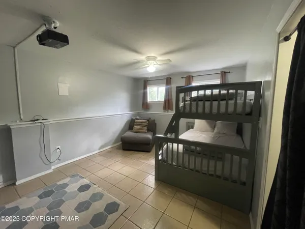 a bedroom with furniture and a window