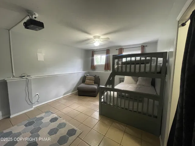 a bedroom with furniture and a window