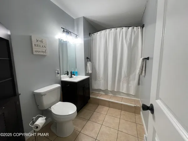 a bathroom with a toilet a sink and bathtub