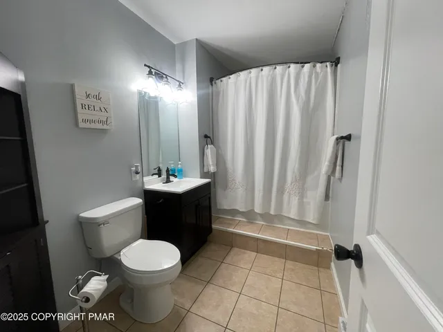 a bathroom with a toilet a sink and bathtub