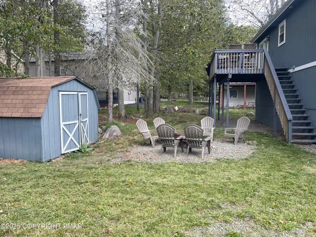 a view of a house with a patio and a yard