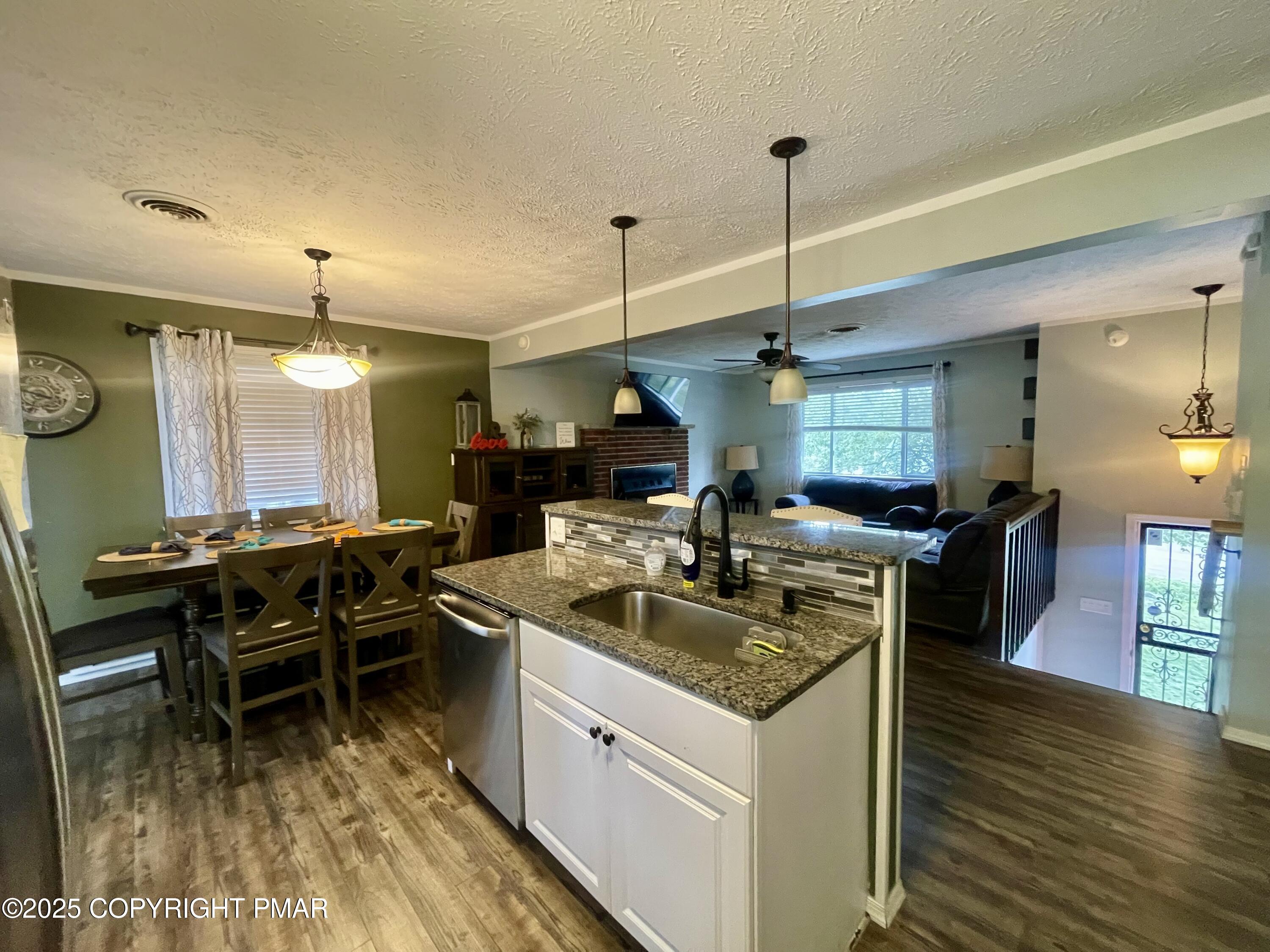 674 Country Pl Drive Tobyhanna, PA 18466 - Photo 5 of 17 a kitchen with kitchen island granite countertop a sink a counter top space and stainless steel appliances