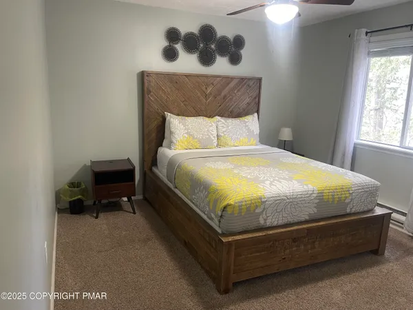 a bed sitting in a bedroom next to a window