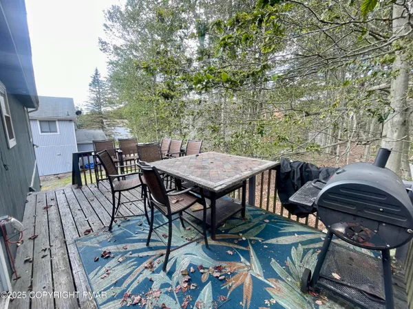 a view of a dinning table and chairs in patio