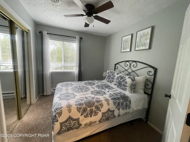a bedroom with a bed next to a window