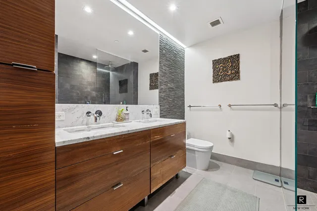 a kitchen with stainless steel appliances a stove a sink and a refrigerator