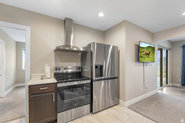 4527 North Seven Bridges Road Eden, UT 84310 - Photo 33 of 65 Kitchen with stainless steel appliances, light colored carpet, dark wood finish cabinetry, light stone counters, and recessed lighting