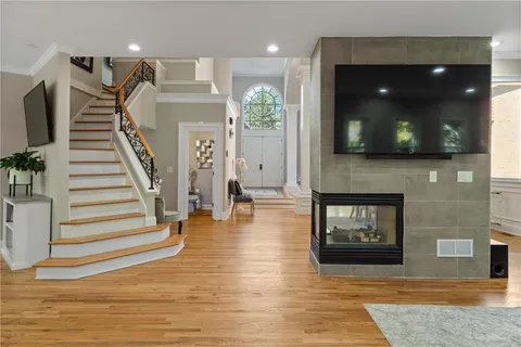 a living room with furniture potted plant and a large window