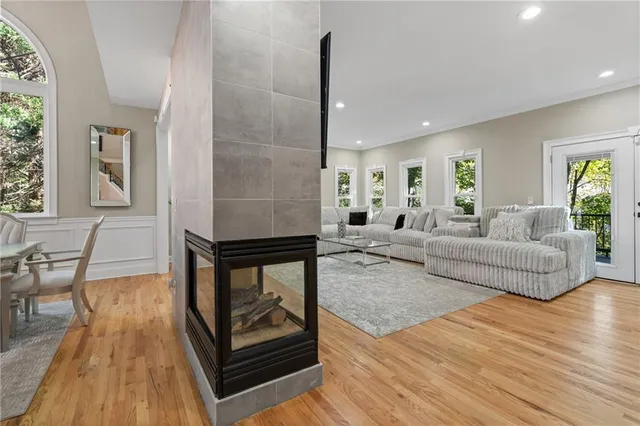 a kitchen with stainless steel appliances a table chairs refrigerator and sink