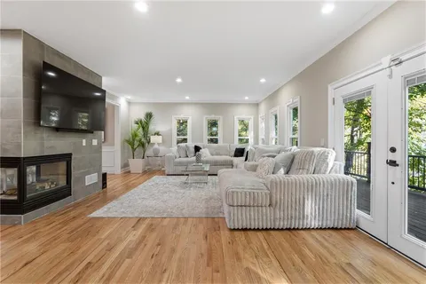 a kitchen with stainless steel appliances a dining table chairs stove refrigerator and cabinets