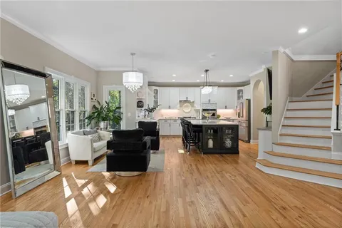 a kitchen with kitchen island granite countertop a sink stainless steel appliances and cabinets