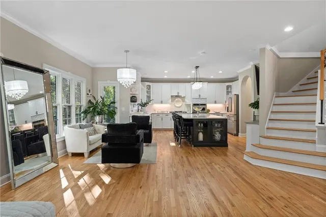 a kitchen with kitchen island granite countertop a sink stainless steel appliances and cabinets