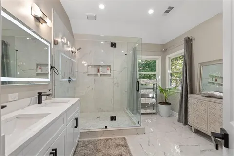 a en suite bathroom with a sink and mirror