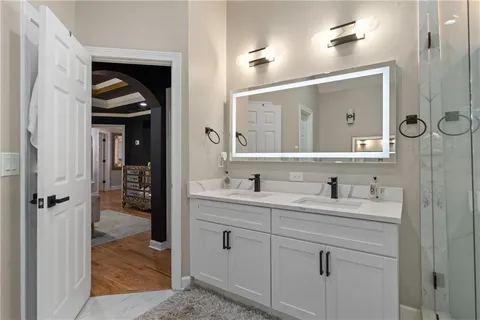 a living room with furniture a flat screen tv and kitchen view