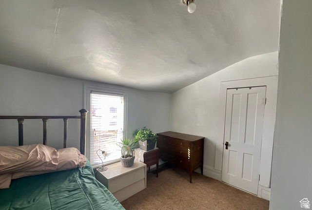 495 North Main Street Beaver, UT 84713 - Photo 15 of 18 Bedroom with vaulted ceiling and carpet flooring