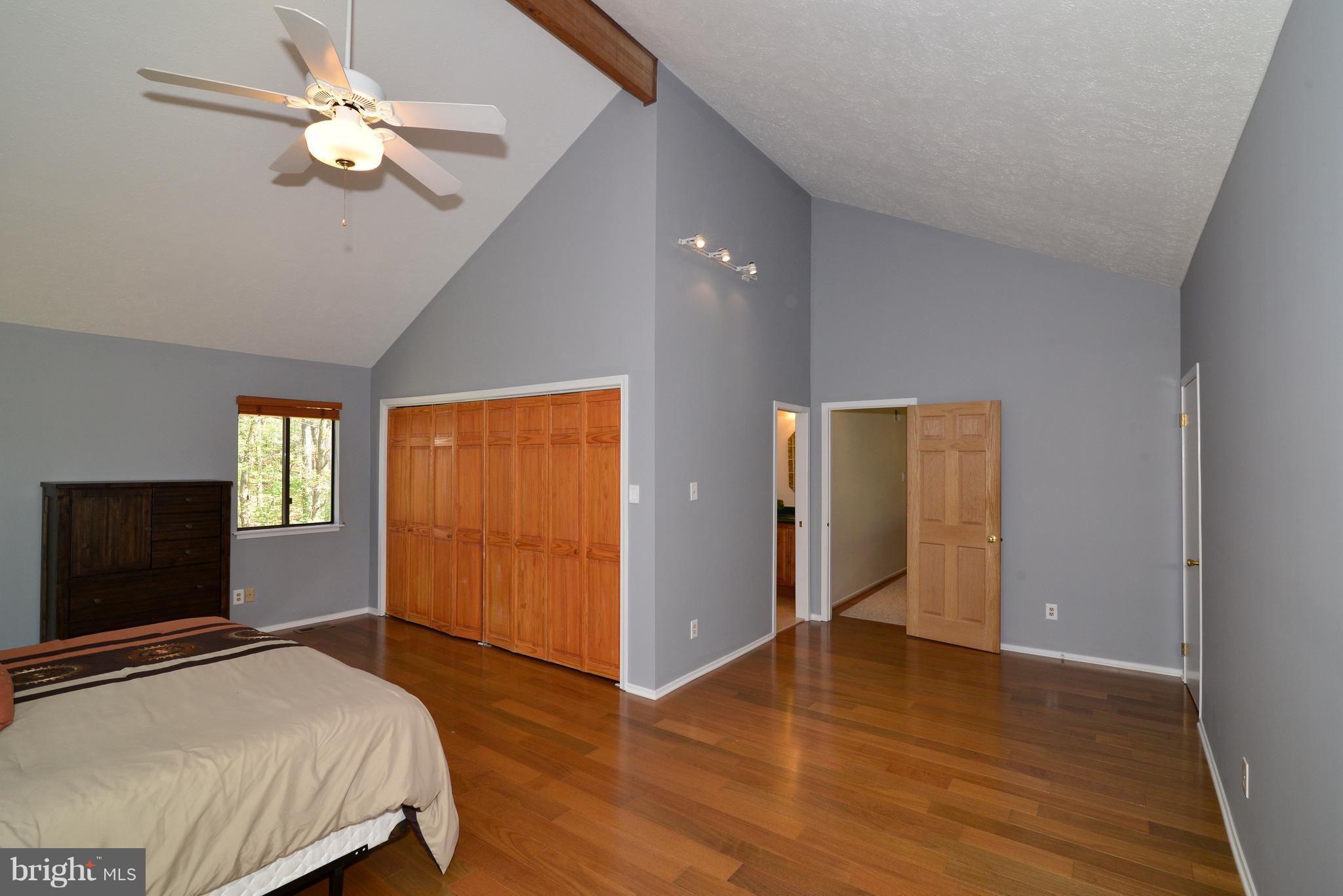 2203 Spinnaker Court Reston, VA 20191 - Photo 17 of 30 a bedroom with a bed and a chandelier