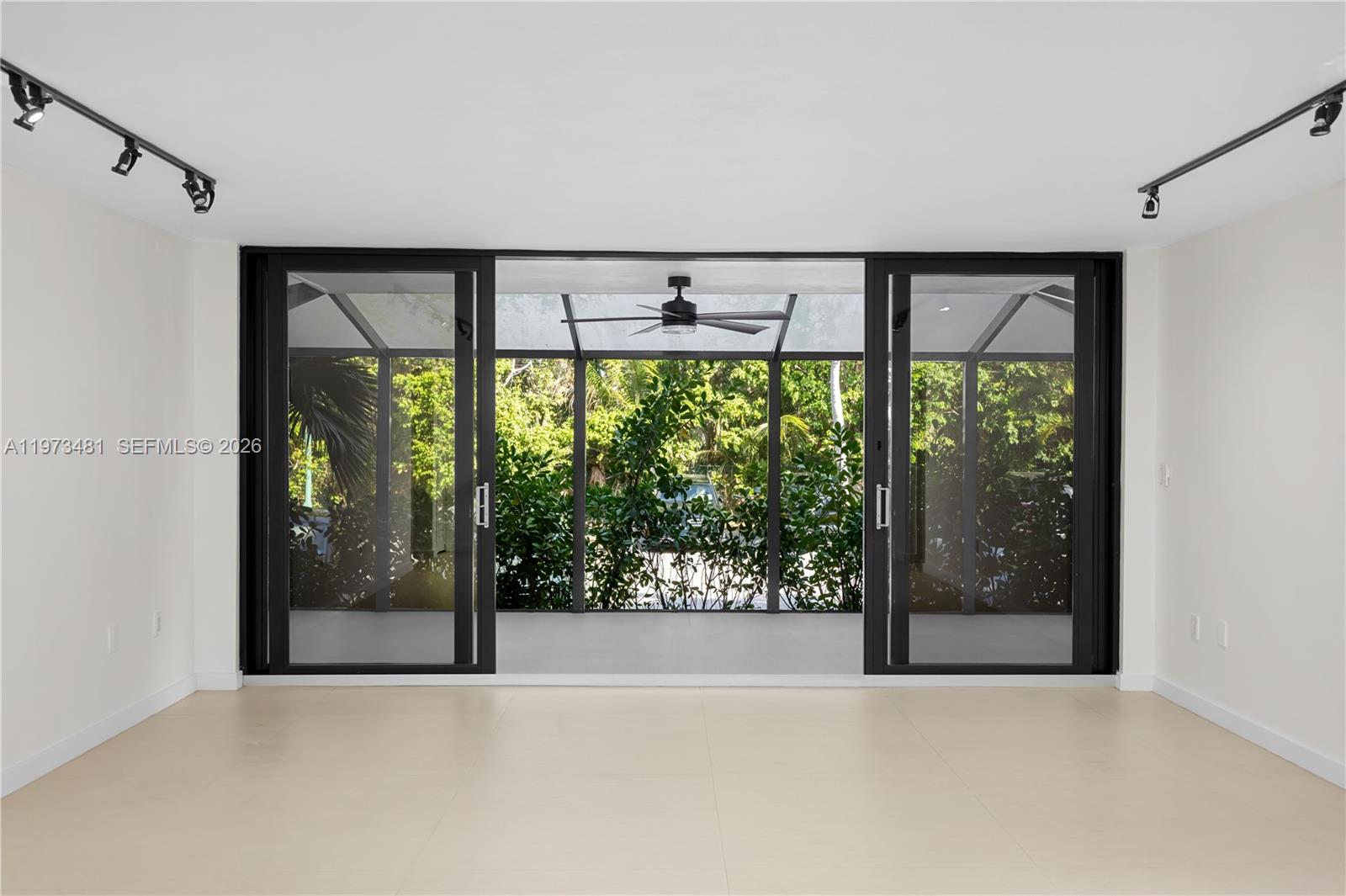 101 Ocean Ln Drive, Unit 1012 Key Biscayne, FL 33149 - Photo 11 of 39 an empty room with sliding glass door and garden