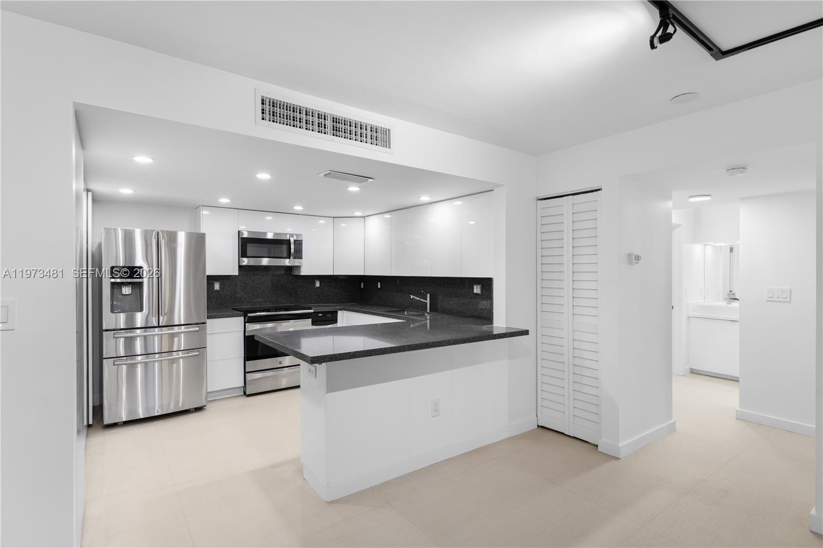 101 Ocean Ln Drive, Unit 1012 Key Biscayne, FL 33149 - Photo 12 of 39 a kitchen with stainless steel appliances kitchen island sink stove and refrigerator