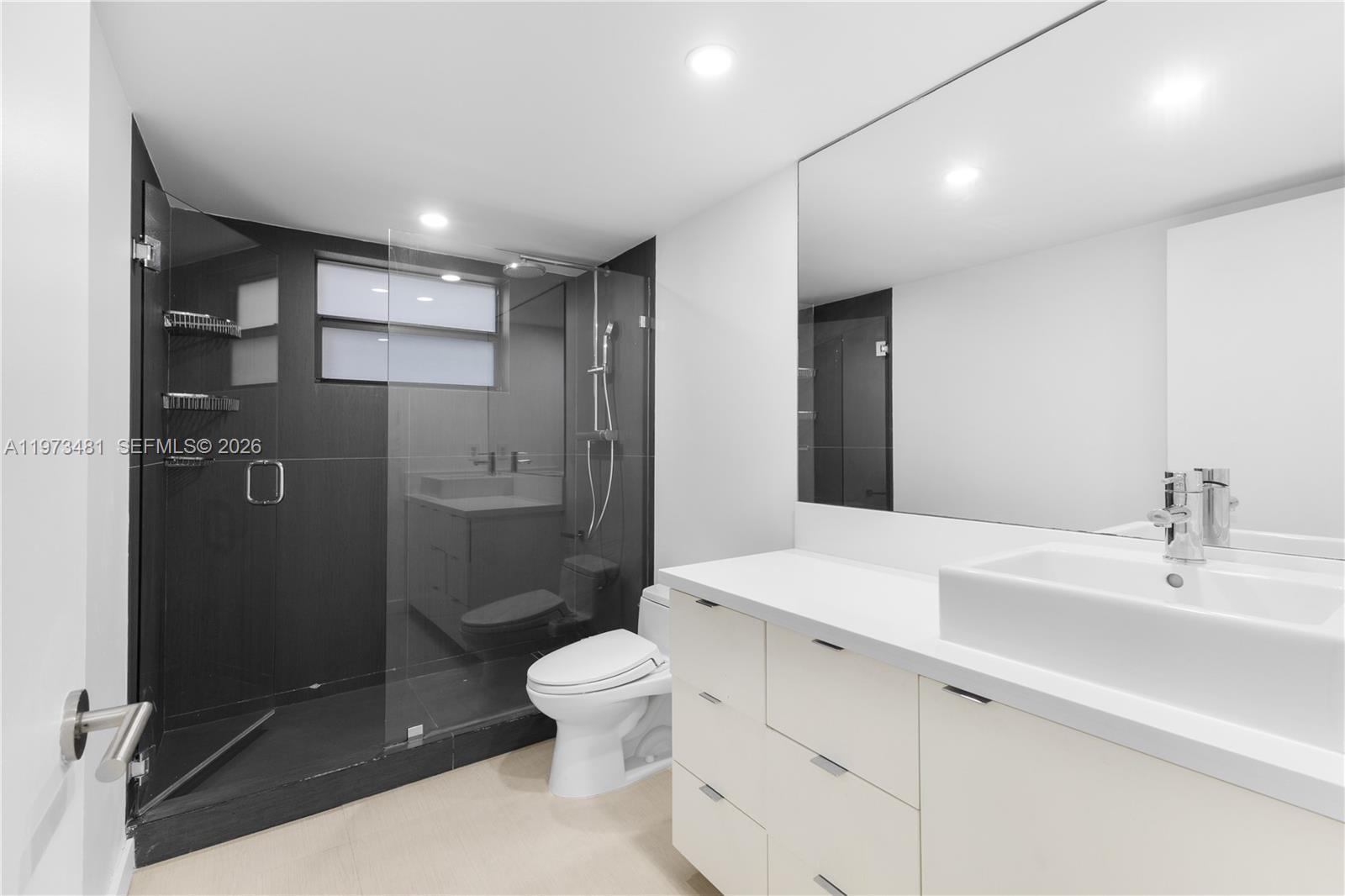 101 Ocean Ln Drive, Unit 1012 Key Biscayne, FL 33149 - Photo 21 of 39 a bathroom with a sink a toilet and shower