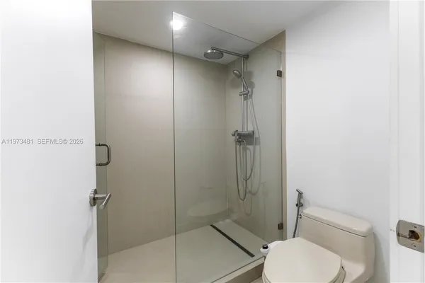 a bathroom with a shower and toilet