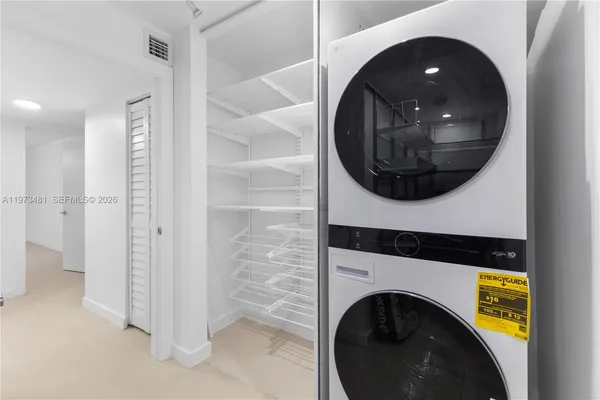 a view of a hallway with washer and dryer