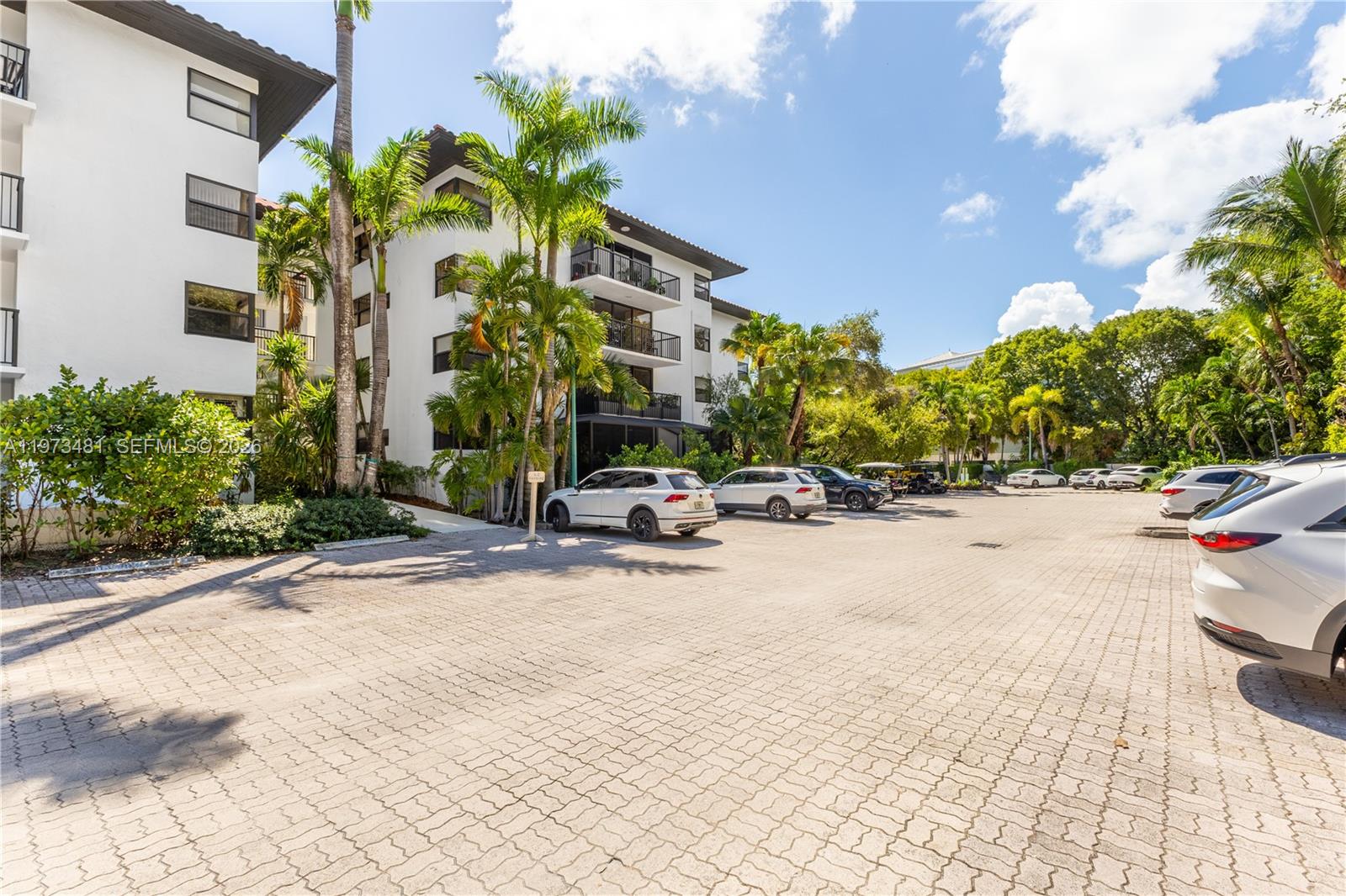 101 Ocean Ln Drive, Unit 1012 Key Biscayne, FL 33149 - Photo 27 of 39 a view of a patio with a table and chairs under an umbrella
