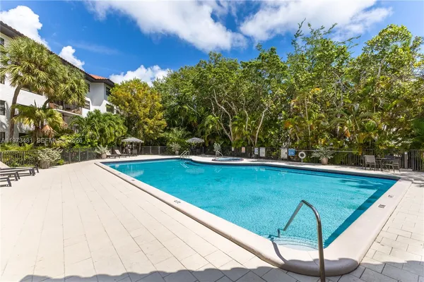 a view of a swimming pool with an outdoor seating