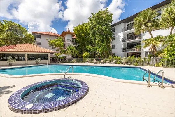 a view of swimming pool with outdoor seating and plants