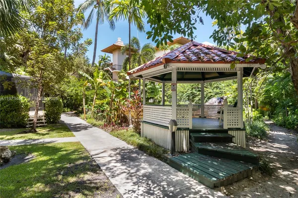 a view of a patio with a table and chairs under an umbrella
