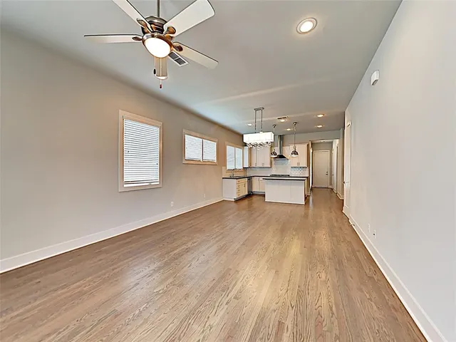 a view of a house with wooden floor and a ceiling fan