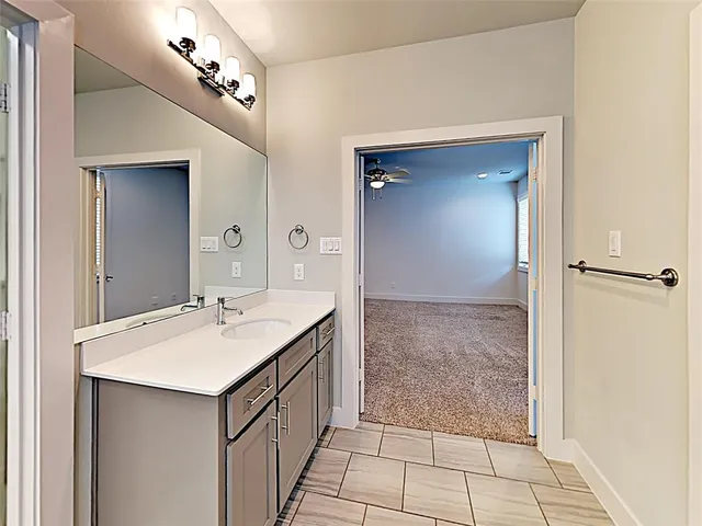 a bathroom with a sink vanity and mirror
