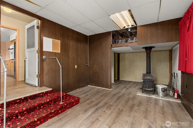 a view of a room with wooden floor and windows