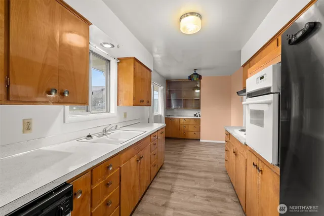 an empty room with a window and cabinet