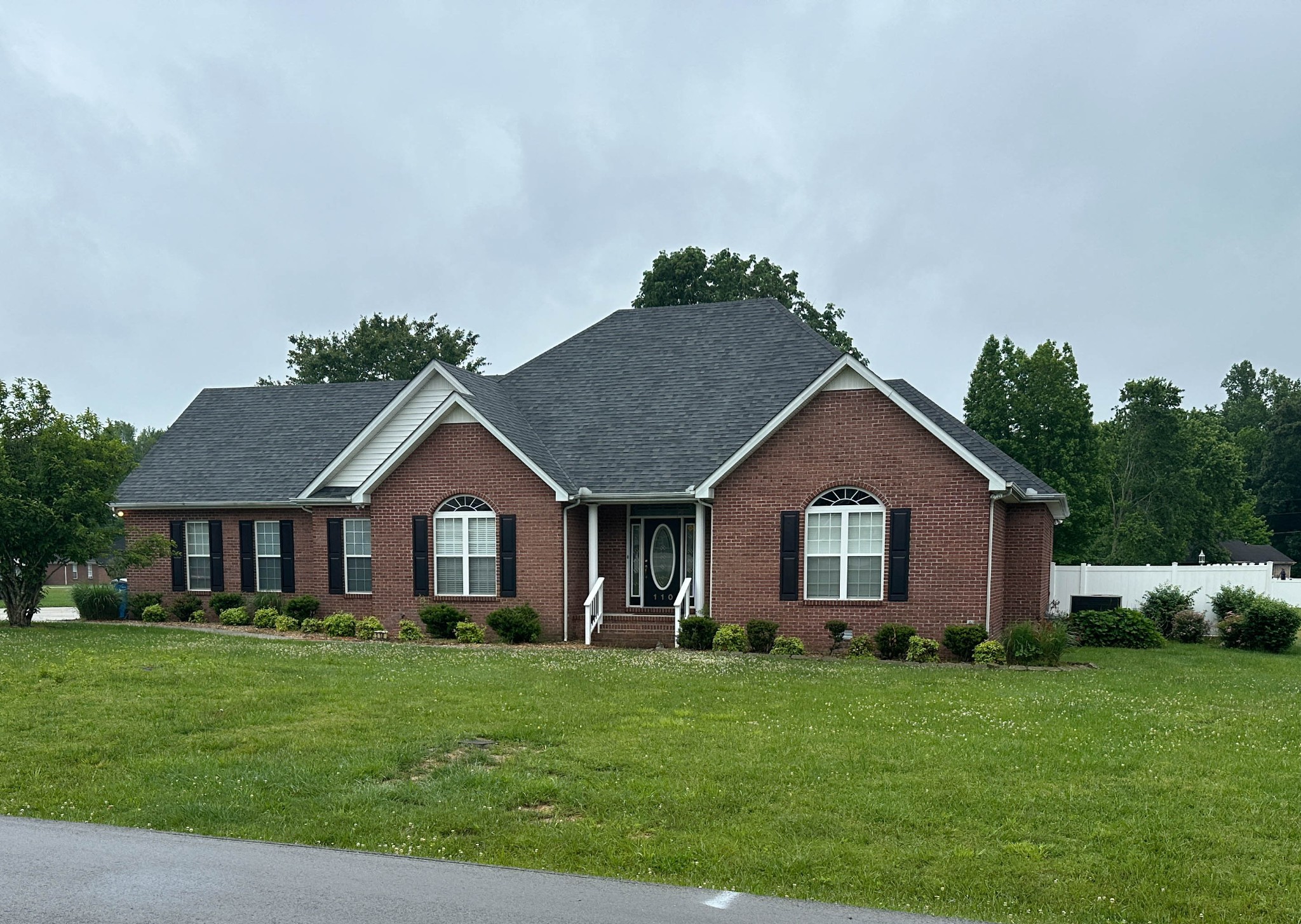 110 Post Road Manchester, TN 37355 - Photo 3 of 68 a front view of a house with a garden and trees