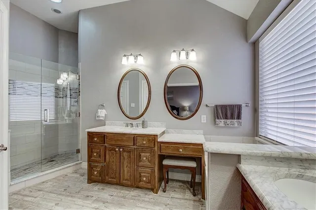 a spacious bedroom with a bed ceiling fan and a window