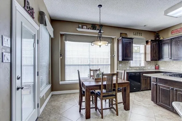 a kitchen with stainless steel appliances granite countertop a refrigerator stove top oven and sink