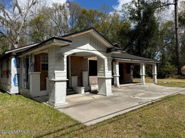 a front view of a house with a yard and porch